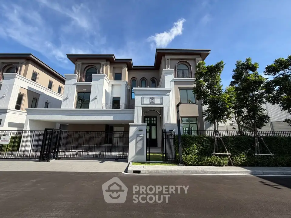 Luxurious modern villa with elegant facade and lush greenery in a prestigious neighborhood.