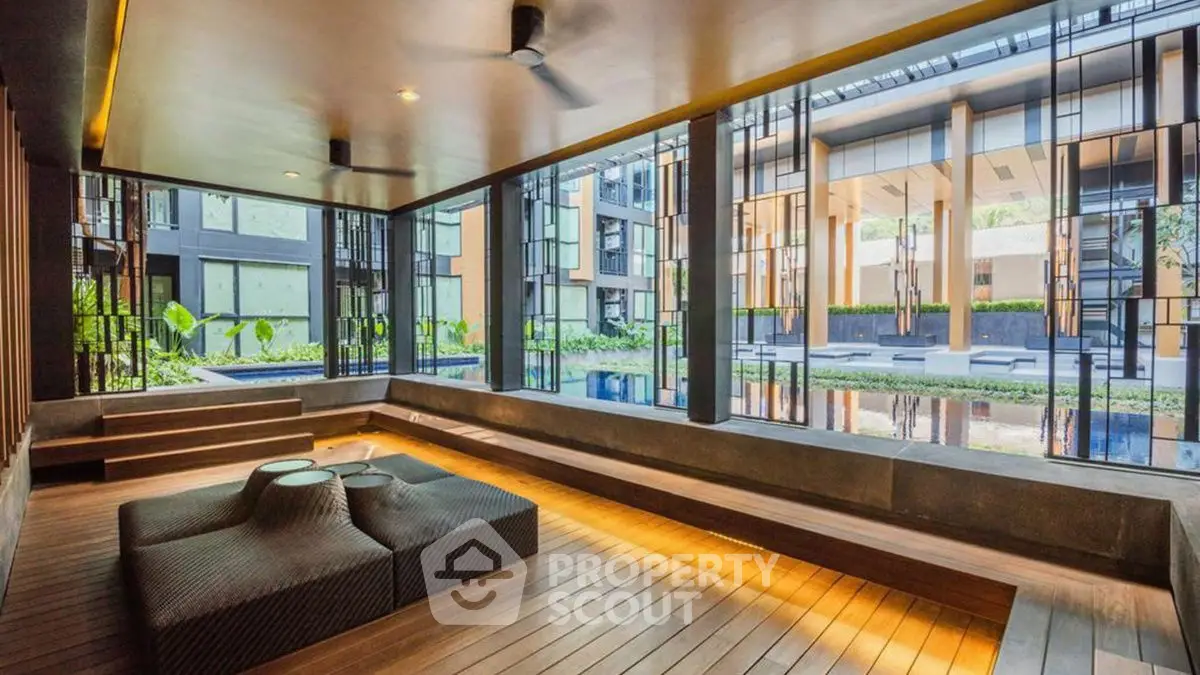 Luxurious modern building with stylish interior and pool view, perfect for upscale living.