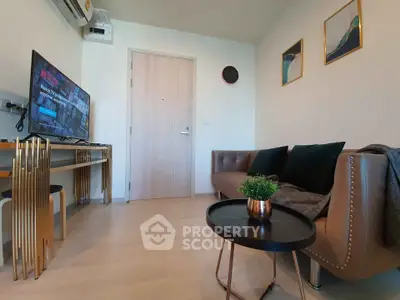 Modern living room with stylish furniture and wall art, featuring a sleek TV setup and cozy seating area.