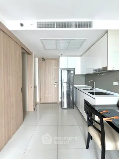 Modern kitchen with sleek cabinetry and stainless steel appliances in a bright, open layout.