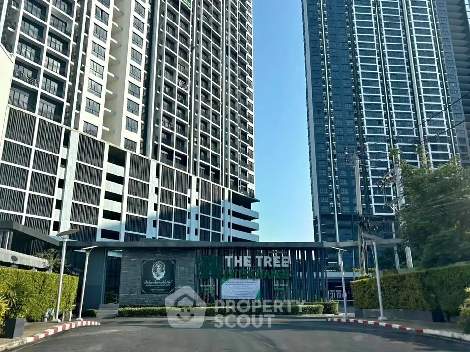 Modern high-rise condominium with sleek architecture and lush landscaping at The Tree Interchange.