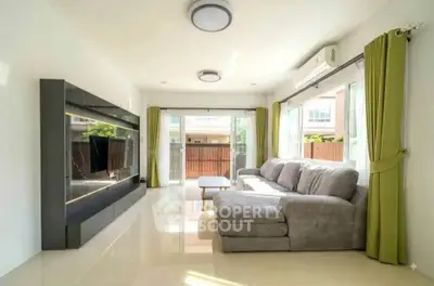 Spacious living room with modern decor and large windows for natural light