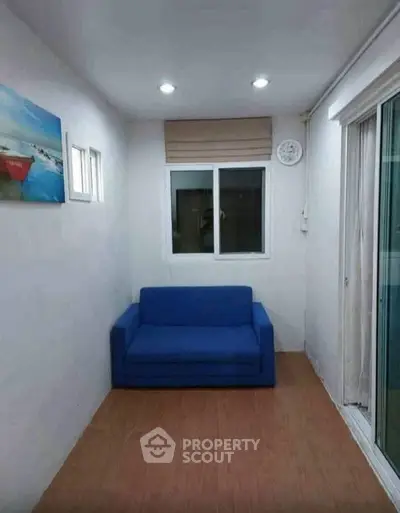 Cozy small living room with blue sofa and modern decor