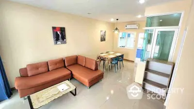 Spacious living room with modern furniture and dining area, perfect for family gatherings.