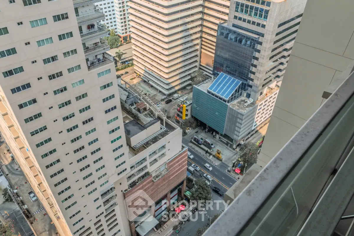 Stunning aerial view of urban high-rise buildings in a bustling cityscape, showcasing modern architecture and vibrant streets.