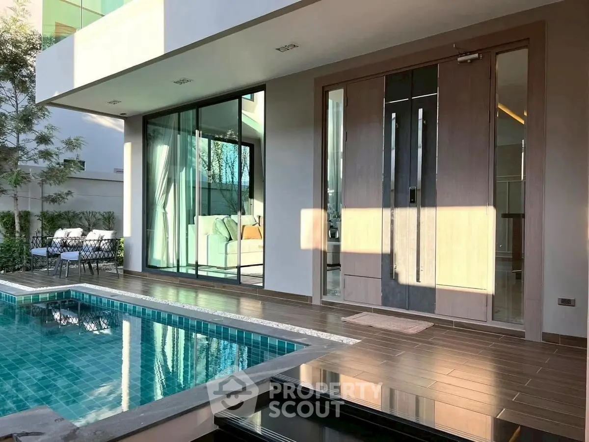 Luxurious modern home with private pool and elegant entrance, perfect for relaxation and entertainment.