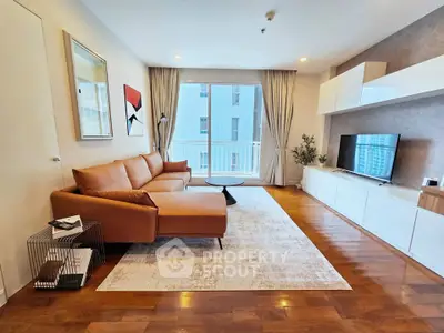 Spacious modern living room with elegant decor and large windows in a luxury apartment.