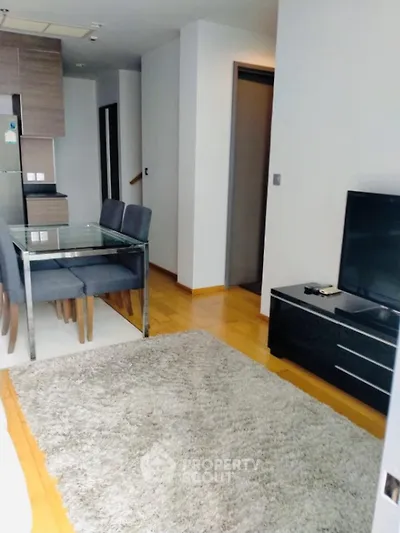Modern living room with dining area and TV in stylish apartment