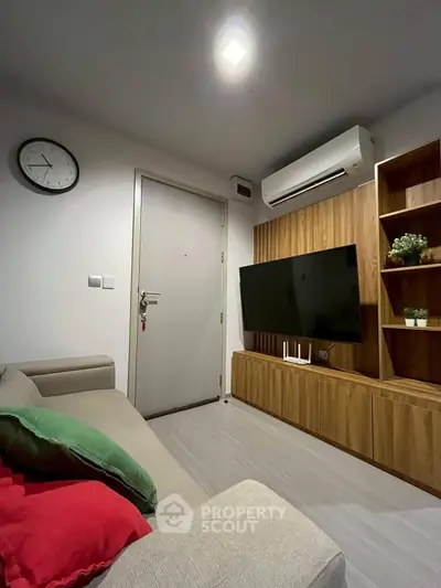 Modern living room with sleek furniture and wall-mounted TV