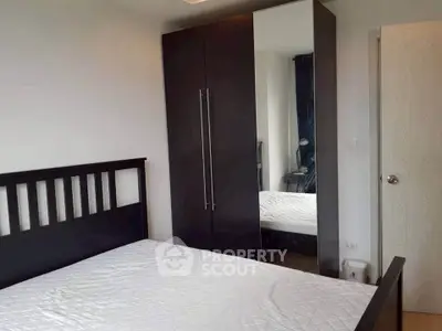 Modern bedroom with sleek wardrobe and comfortable bed in stylish apartment.