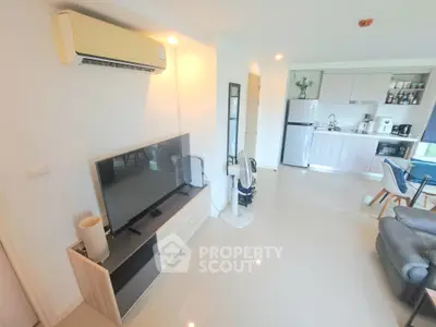 Modern living room with sleek furniture and open kitchen layout