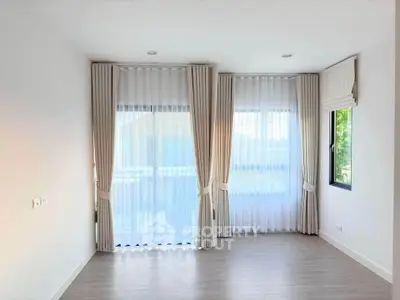 Bright empty room with large windows and elegant curtains, perfect for customization.