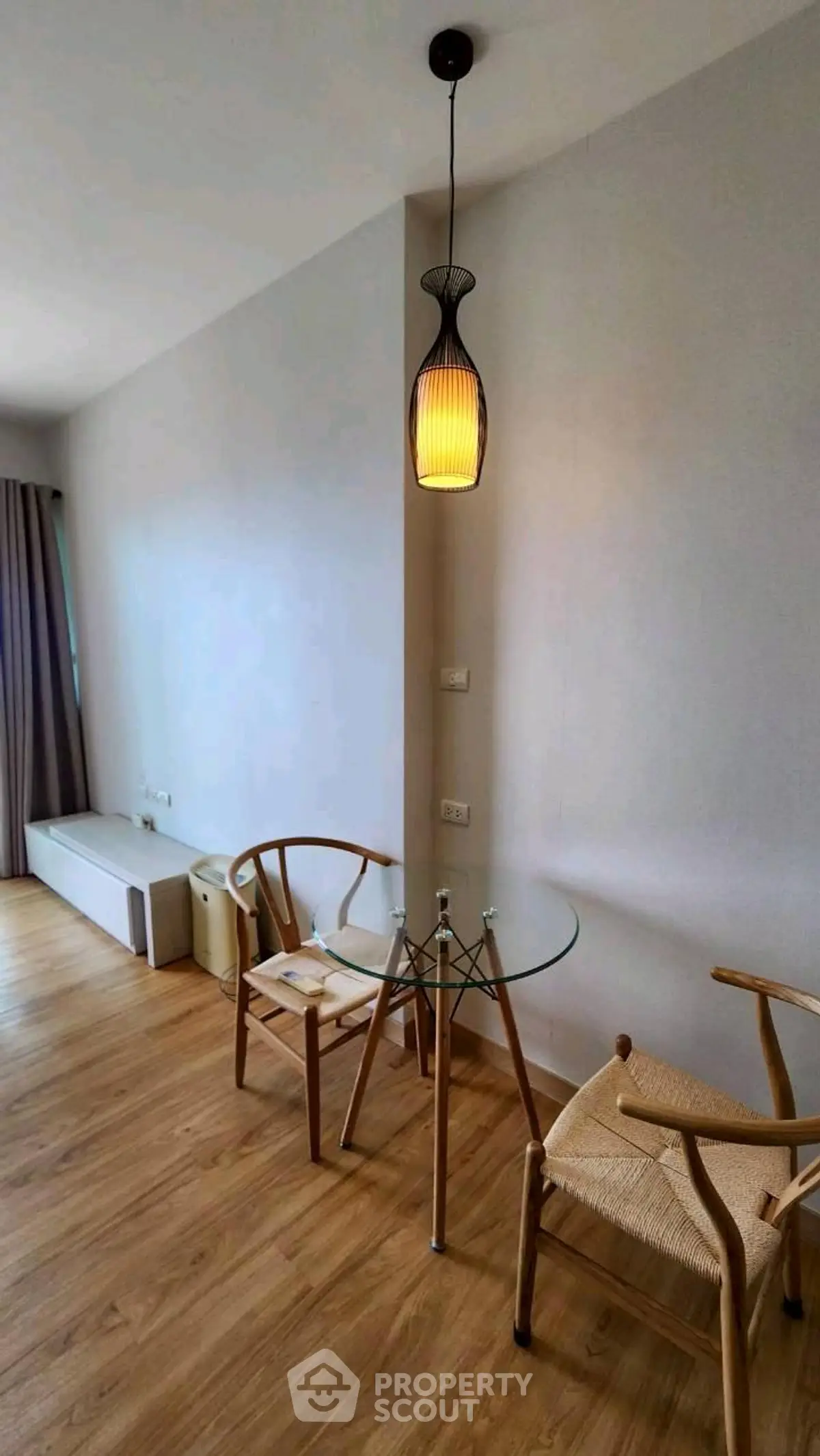 Chic modern living room with stylish chairs and glass table, perfect for cozy gatherings.