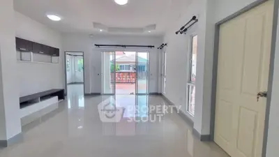 Spacious living room with glossy floors and large windows for natural light.