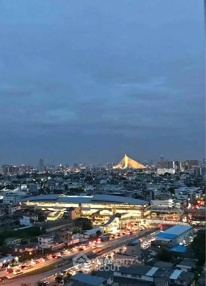 Stunning cityscape view with iconic bridge and bustling city lights at dusk.