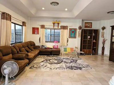 Spacious living room with cozy brown sectional sofa and large windows