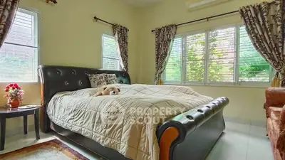 Cozy bedroom with elegant decor and large windows offering natural light