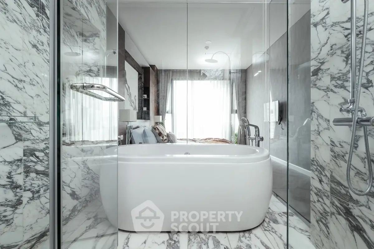 Luxurious marble bathroom with elegant freestanding bathtub and modern fixtures.