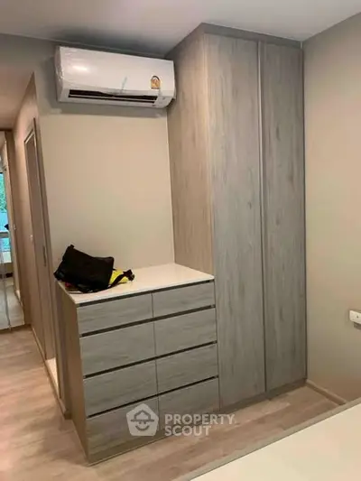 Modern bedroom with sleek wardrobe and air conditioning unit
