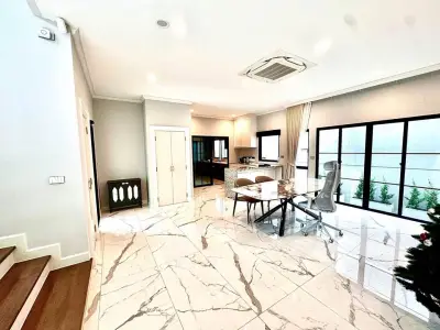 Spacious modern living room with marble flooring and large windows, perfect for stylish urban living.