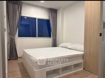 Modern minimalist bedroom with large window and stylish curtains