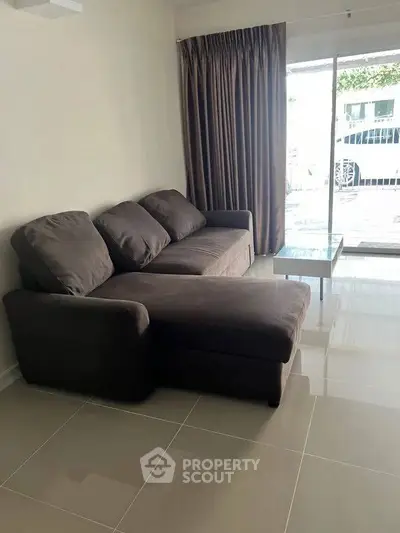 Spacious living room with modern sofa and large window view
