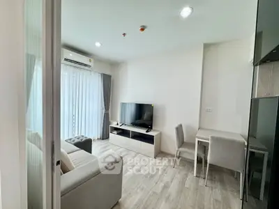 Modern living room with sleek furniture and natural light in a stylish apartment.