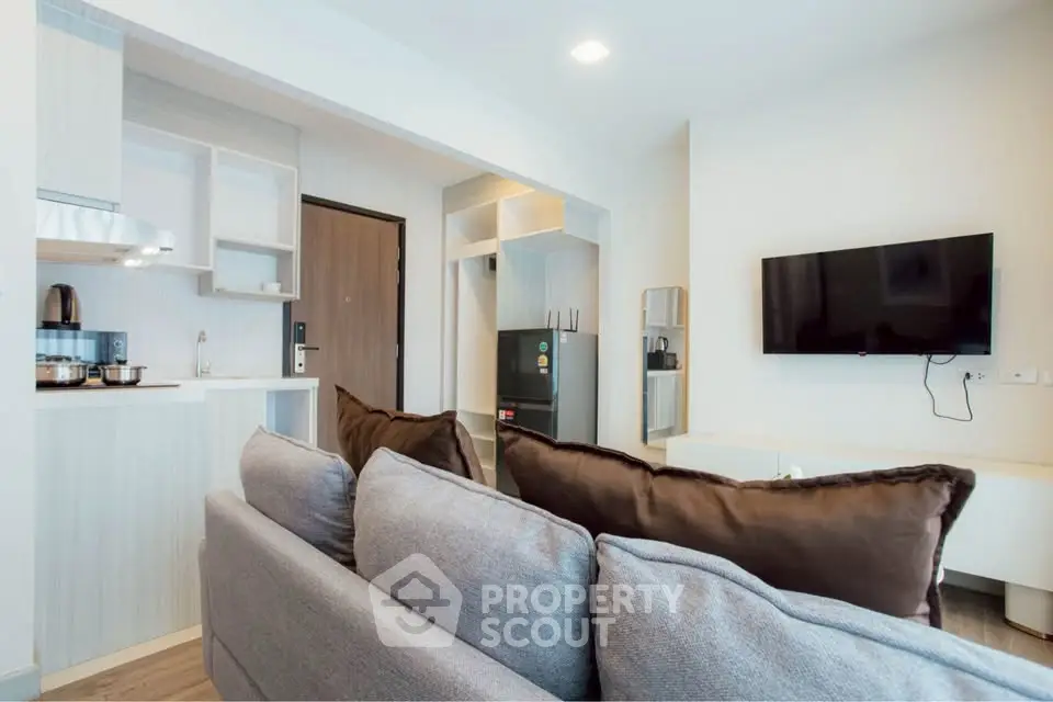 Modern living room with open kitchen and sleek decor