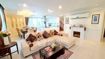 Luxurious open-concept living room with elegant decor and modern kitchen