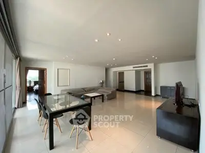 Spacious modern living room with sleek furniture and ample natural light