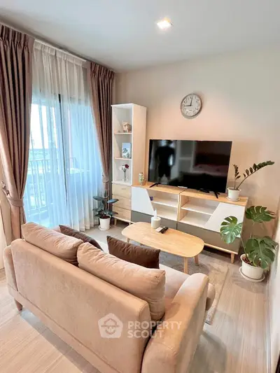 Modern living room with cozy sofa, TV, and balcony view