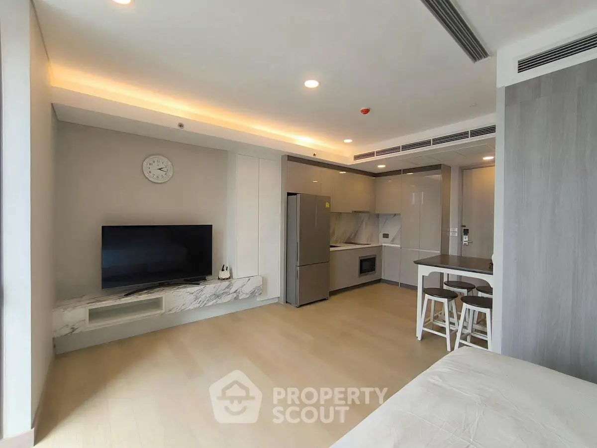 Modern open-plan living room with sleek kitchen and stylish decor