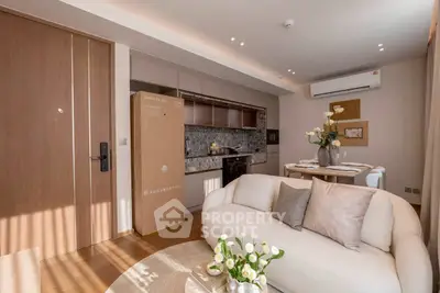 Modern living room with open kitchen, stylish decor, and natural light