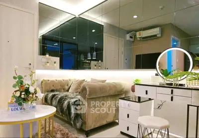 Luxurious living room with plush sofa, mirrored wall, and elegant decor in modern apartment.