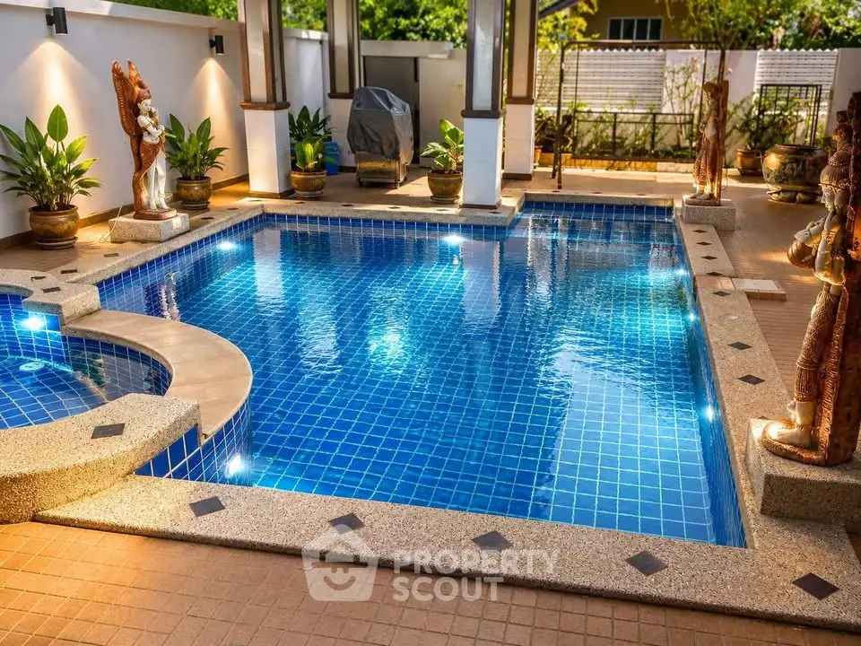 Luxurious private pool with elegant statues and serene ambiance in a modern villa setting.
