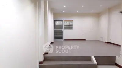 Spacious interior with elevated platform and modern lighting, ideal for versatile use.