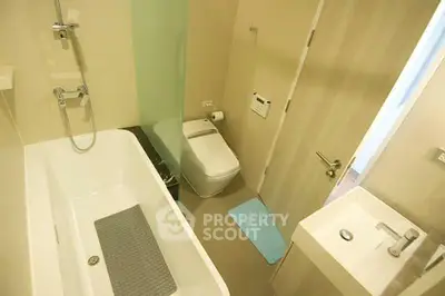 Modern bathroom with sleek fixtures and bathtub in contemporary apartment.