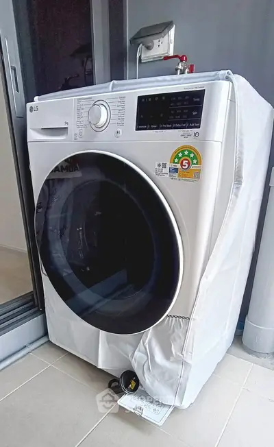 Modern washing machine on balcony with protective cover, ideal for urban apartments.