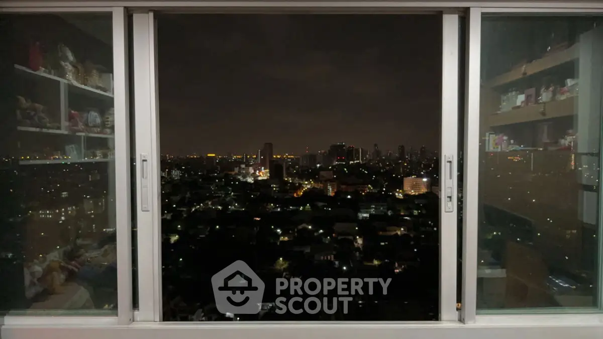 Stunning city skyline view from a modern apartment window at night.