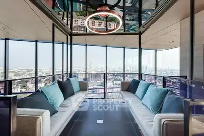 Luxurious high-rise living room with panoramic city views and modern decor.