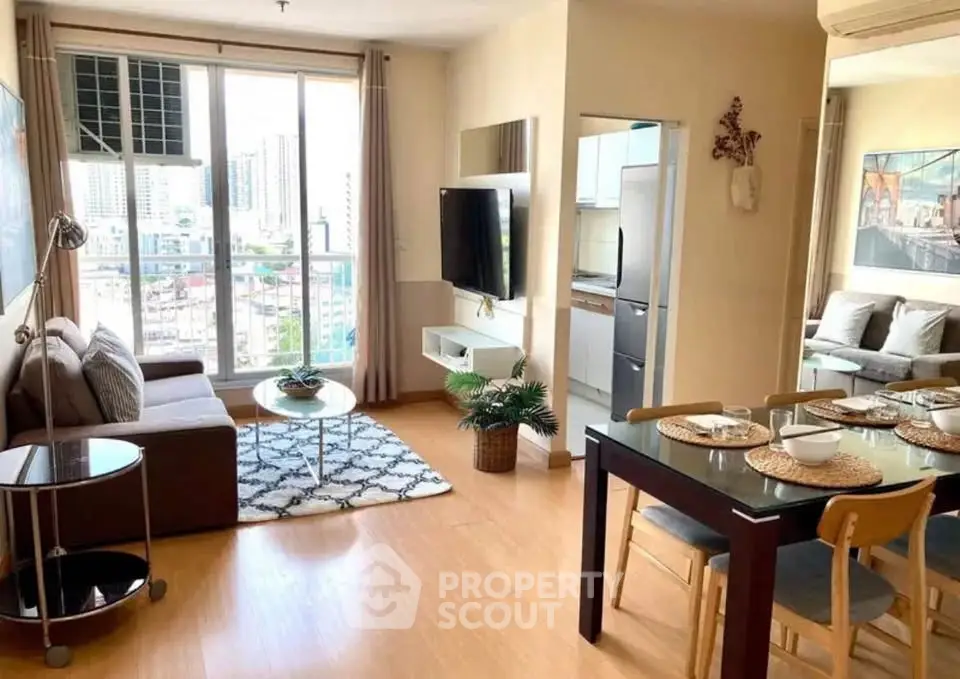 Modern living room with dining area and city view, featuring stylish decor and natural light.