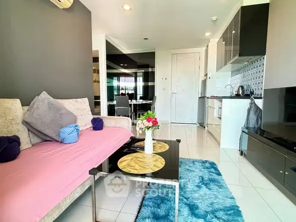 Modern living room with stylish decor and open kitchen layout in a cozy apartment.