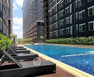 Luxurious apartment complex with a stunning outdoor pool and modern architecture.