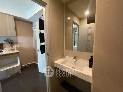 Modern bathroom with sleek sink and mirror in contemporary apartment