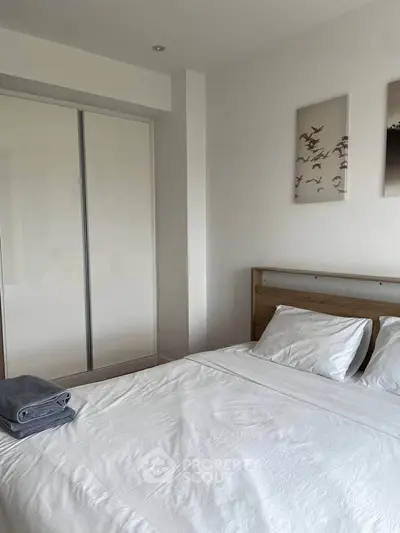 Cozy bedroom with modern decor and ample closet space.