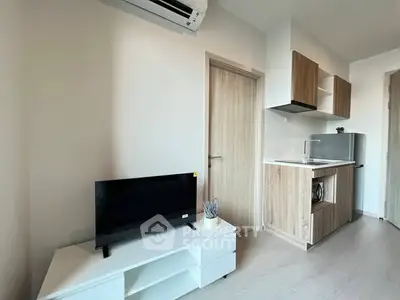 Modern compact living room with kitchenette and sleek design