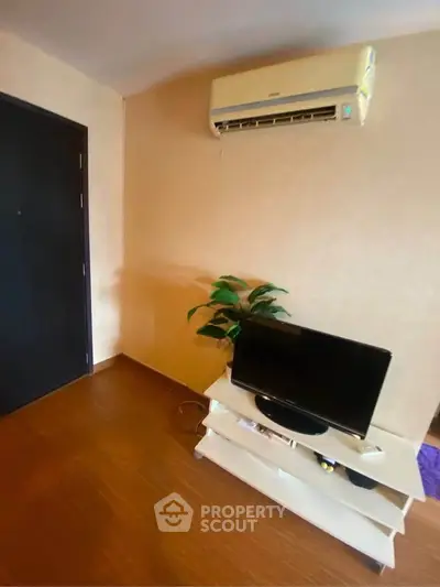 Cozy living room with air conditioning and modern TV setup