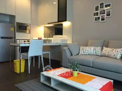 Modern open-layout kitchen and living room with stylish decor and cozy ambiance.