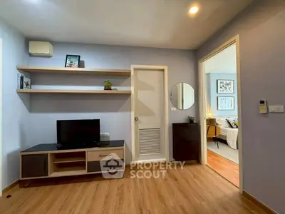 Modern living room with sleek TV stand and wooden flooring