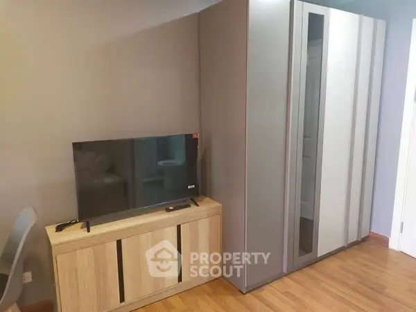 Modern living room with sleek TV stand and stylish wardrobe